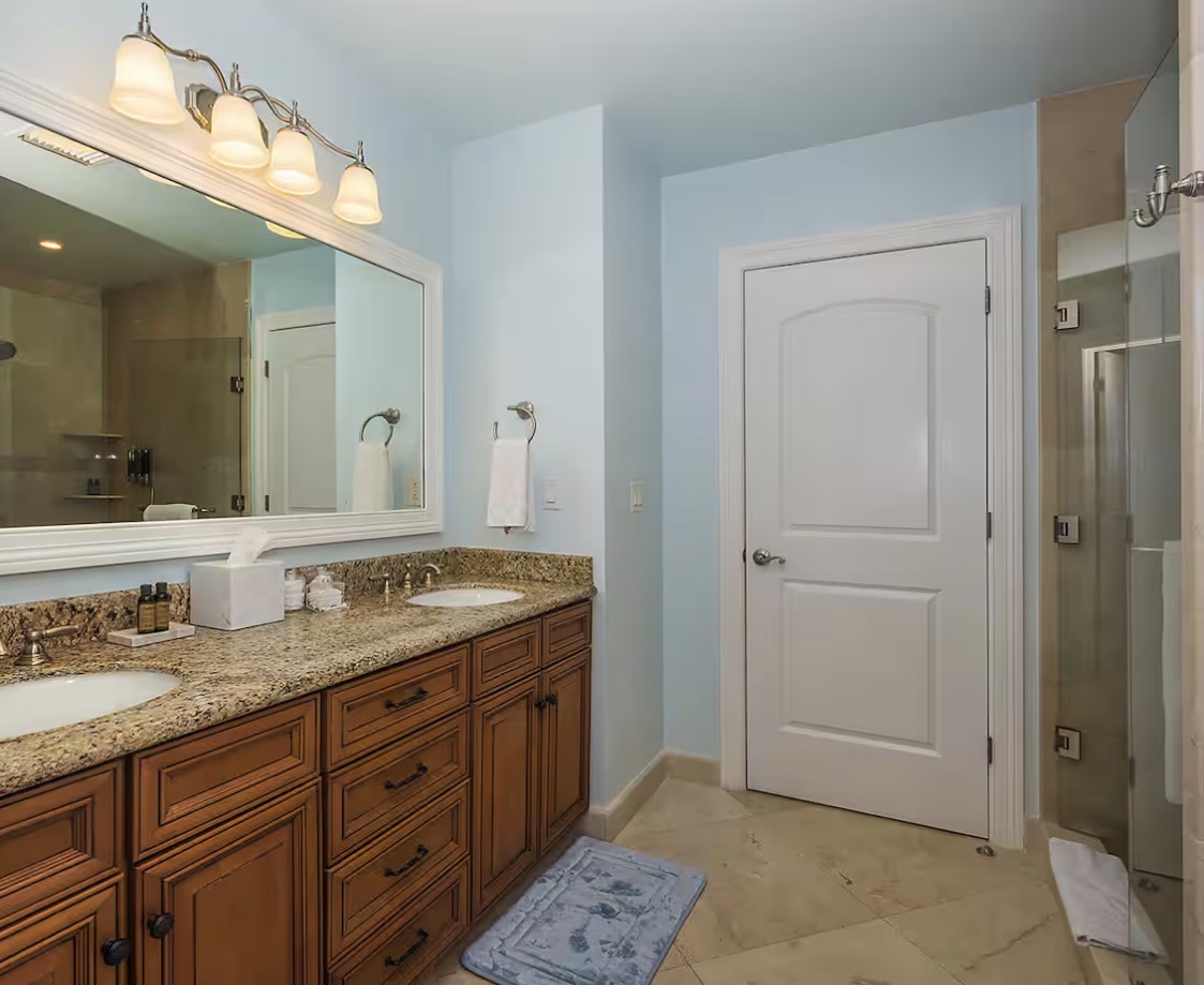 Condo 510 bathroom with dual vanity and walk-in shower