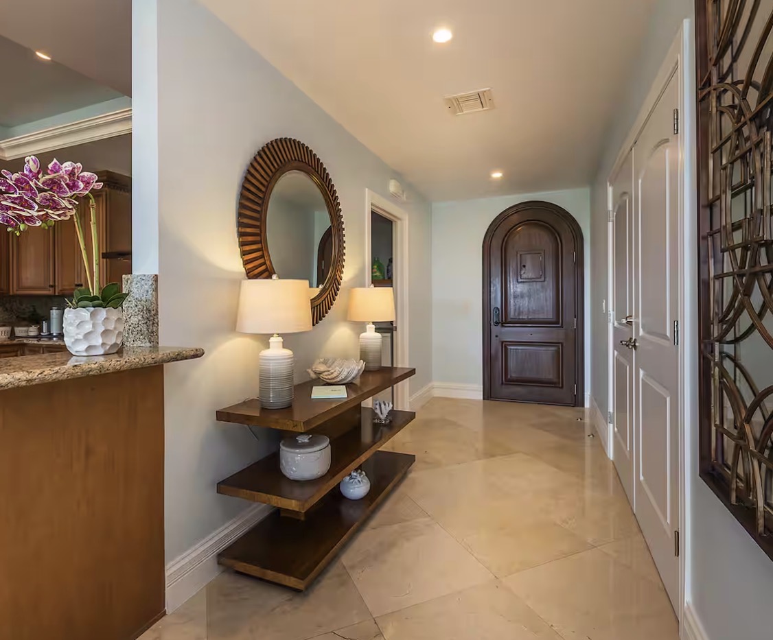 Condo 510 entry foyer with arched mahogany door