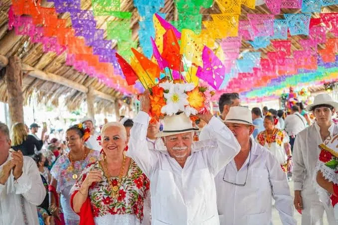 Locals in traditional white dress celebrating at a Cozumel fiesta