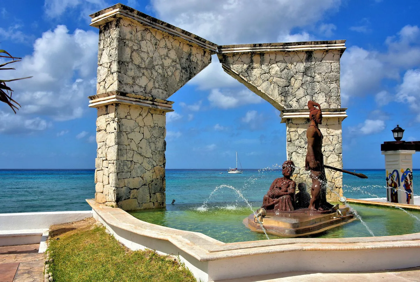 The Monumento al Mestizaje sculpture on Cozumel's waterfront, with the Caribbean Sea behind